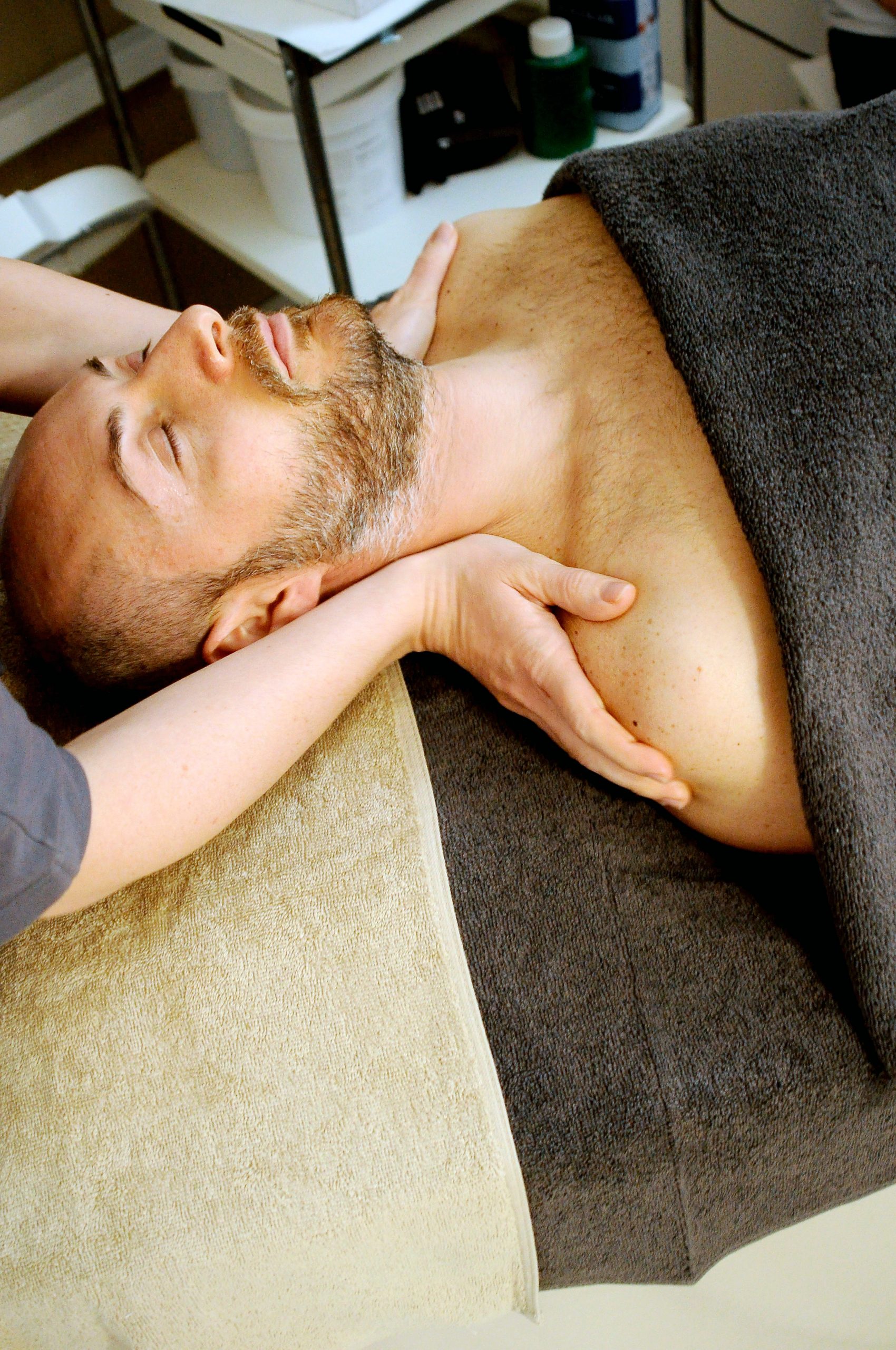 man being massaged on shoulders